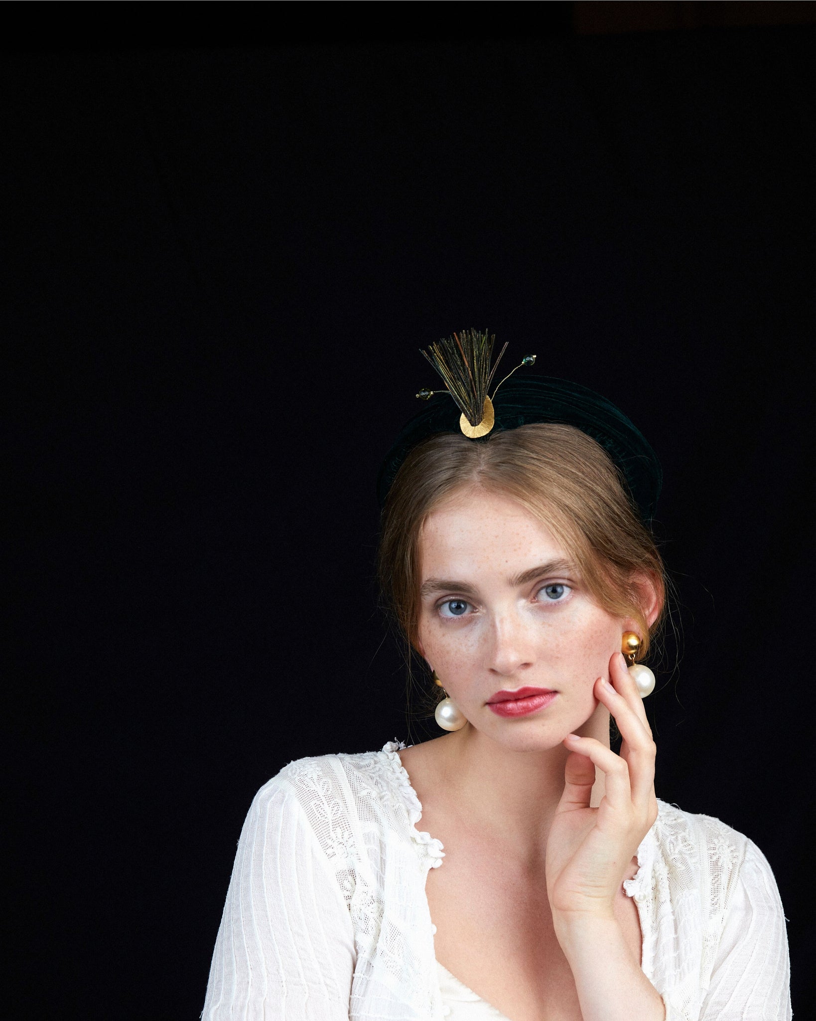 HEADQUARTER | couture headwear Cocktail hat in deep green color. Made of velvet, trimmed with peacock feathers, beads, and golden wire. Designed and handcrafted in Switzerland.